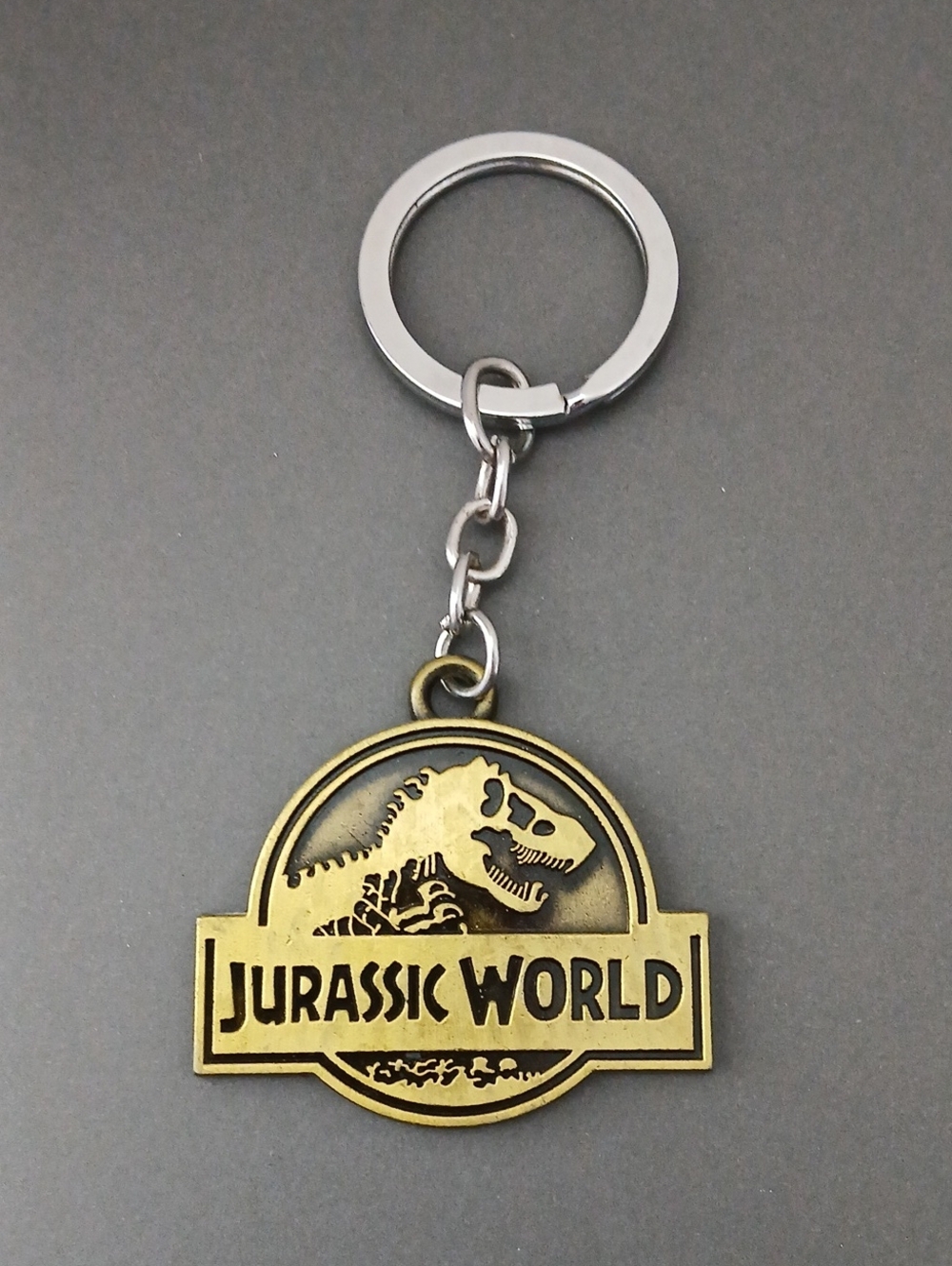 Gold Colored Jurassic World Keychain